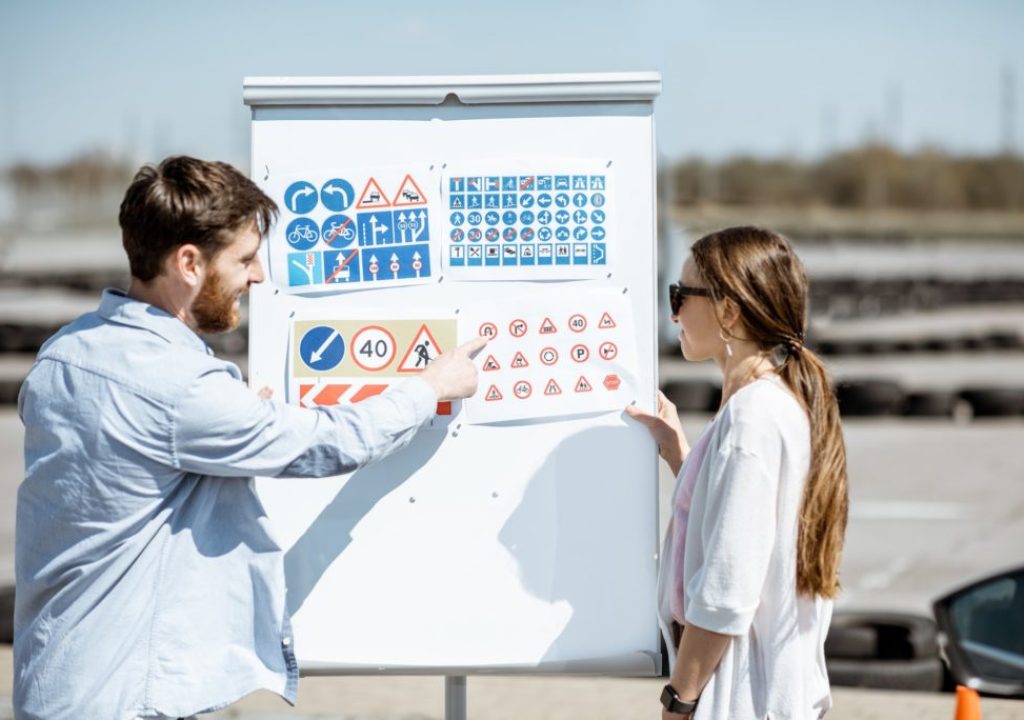 driver-instructor-with-student-on-the-training-ground-outdoors.jpg